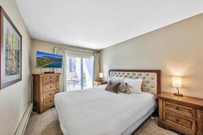 The bedroom has a plush king sized bed, 40-inch HDTV, and balcony access