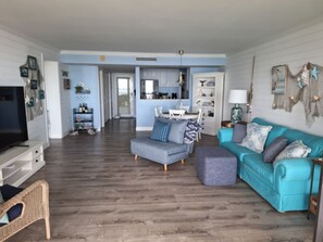 Spacious open living room area with sleeper couch