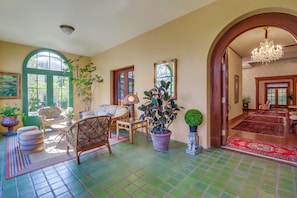 Enter the home through the sunroom, a second living area providing a bright and airy space to relax and unwind.