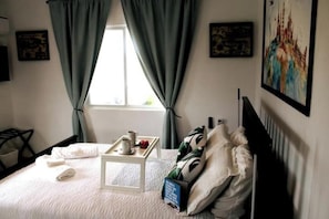 Master bedroom with a comfy queen size bed, pillows, a/c, ceiling fan,Smart T.V.