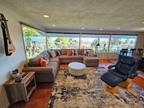 Upstairs living room, feels like you’re in the trees, great view of the water.