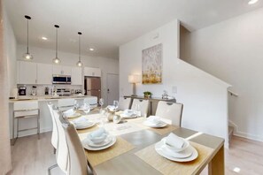 Gather around the large dining table for memorable meals together.