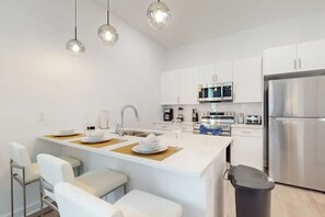Cook with ease in the fully stocked kitchen with modern appliances.