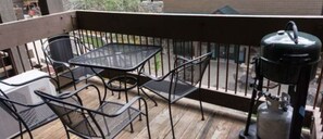 Enjoy the fresh air and outdoor dining with this private balcony, complete with seating and a grill.