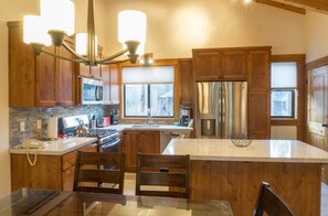 Fully-equipped kitchen with modern amenities, ample counter space, and wooden cabinets, ideal for preparing delicious meals.