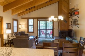 Open-plan dining and living area, featuring a large dining table, comfortable seating, and a warm, inviting atmosphere.