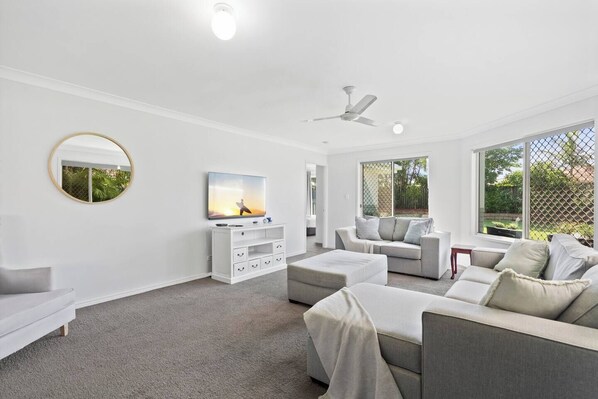 Spread out in the living area, with plush sofa seating and a TV for your evening entertainment.
