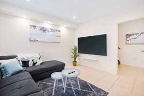 Unwind on the sofa while enjoying your favorite TV shows on the impressive 75-inch screen.