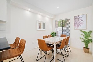 A large dining table makes it easy for guests to come together for a shared meal at home.
