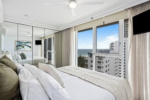 The second bedroom also features a king-size bed with ocean and city views.