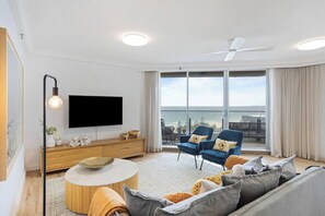 The cosy living area includes a sofa and armchairs to settle in with a movie after a day of sightseeing.
