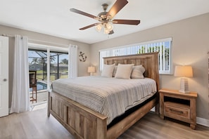 Primary bedroom with king bed, attached bathroom, and 50-inch Smart TV