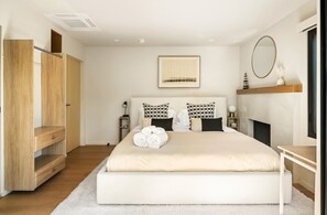 Unwind in the comfort of a bright and spacious bedroom featuring a king-sized bed, plush bedding, and fresh linens. The perfect spot to rest and recharge.
