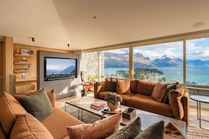 Luxury Comfort and Modern Design in Queenstown
This sophisticated living area blends modern design with cozy luxury, featuring plush seating and a fireplace, perfect for unwinding after exploring Queenstown's ski fields or wine tours.