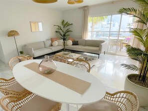Bright and spacious lounge with dining area and terrace access
