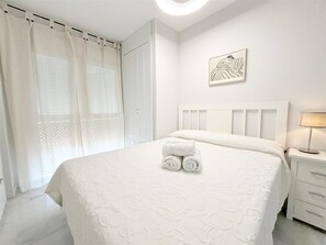Master bedroom with king-size bed and air conditioning
