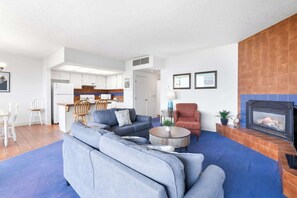 Spacious open-concept layout seamlessly connects the cozy living room, fully equipped kitchen, and dining area. Perfect for socializing, dining, and relaxation.