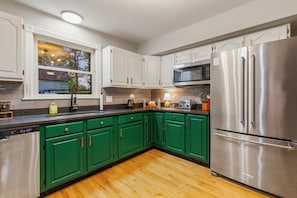 Spacious kitchen with brand new stainless appliances and granite countertop