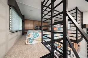 King mattress in the large loft with storage and electric fireplace!