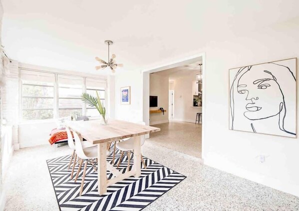 Enjoy lunch or dinner by the windows  in this minimalist area of the house called the dinning room