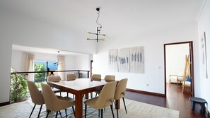 Spacious dining room featuring a sleek square table, perfect for gatherings, with ample natural light and a cozy ambiance. #spacious