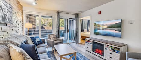 Living Room: Couch w/pull out bed, 2 chairs, gas fireplace, 55” TV, entertainment center w/electric fireplace, access to a private balcony