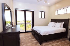 Bedroom 1 has a queen bed and access to the balcony