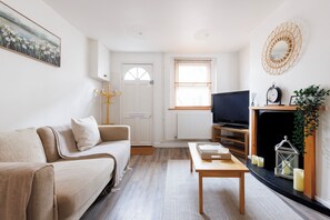 Front door entrance with sofa, tv and coffee table 