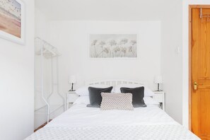 Bedroom with clothes hanger and wall art 