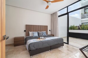 Comfortable bedroom featuring large windows and modern furnishings.