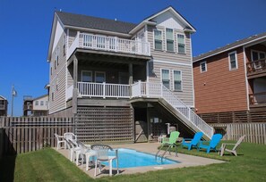 Backyard of Beach Bound & Down Featuring a Custom Concrete Pool