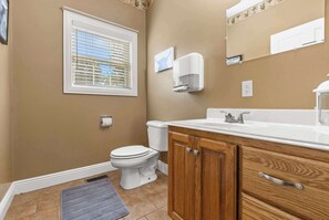 Convenient half bath located just off the entryway from the garage.