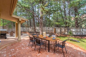 Grill, dine & relax in this spacious patio with BBQ and cornhole game.
