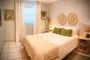Spacious queen sized bed with ceiling fan and tv. 
