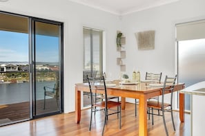 Come together for a shared meal around the dining table while enjoying a backdrop over the water.

