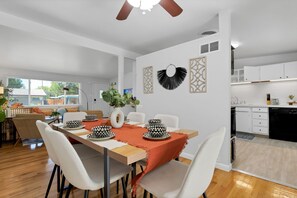 Dining area with ceiling fan, and kitchen steps away