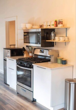 The fully-stocked kitchen has been updated with all new appliances, cabinets, and shelving. 