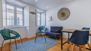 A stylish mix of contemporary furniture and pops of color create a cozy space for relaxing or dining. #StylishLiving #CozyVibes