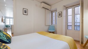 The bedroom opens to a charming balcony, combining comfort and a bright, airy atmosphere. #CityEscape #NaturalLight