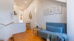 A compact yet inviting living area with colorful decor and minimalist design. #WarmWelcome #ChicLiving