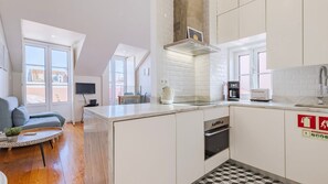 A modern and airy kitchenette with sleek finishes, marble counters, and natural light streaming in. #BrightAndModern #FunctionalDesign