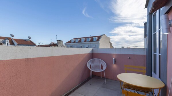 A charming outdoor space with cheerful yellow furniture and rooftop views, perfect for coffee or sunset drinks. #TerraceVibes #OutdoorEscape