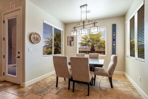 This cozy dining nook seats 5 guests. It's practical and simple, making the outdoor views the highlight of the setting. Enjoy hearty meals surrounded by a warm, inviting ambiance.