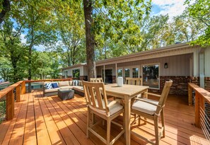 Enjoy your meals al fresco on this spacious deck, surrounded by nature and the calming sound of the lake nearby.