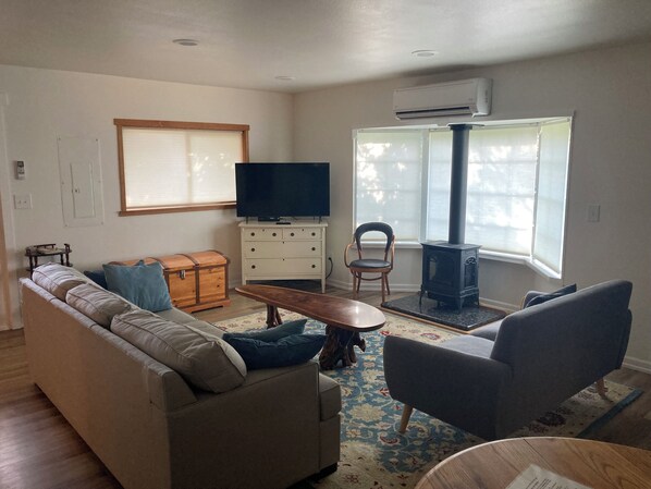 Living room with smart tv, propane fireplace, and sleeper sofa