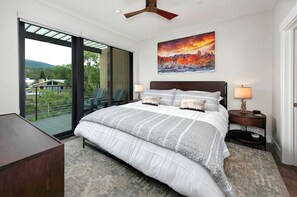 Spacious bedroom with private balcony and King bed overlooking river
