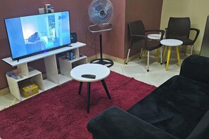 Lounge area with Android TV + Netflix, Powerful Fan, 2 seater sofa, Fast Unlimited Wifi.