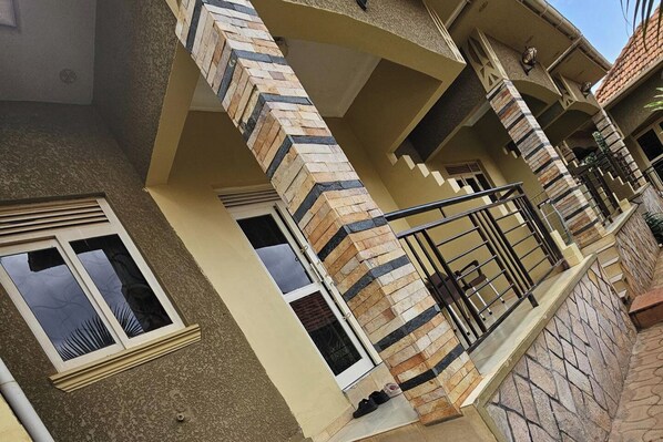 Entrance to apartment up some steps Featuring a balcony.