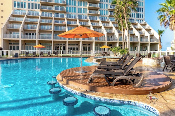 Shaded poolside loungers