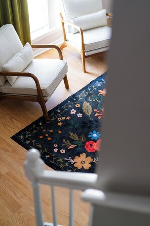 A Sneak Peek from the Stairs to the Stylish Living Room – Step into Comfort and Relaxation